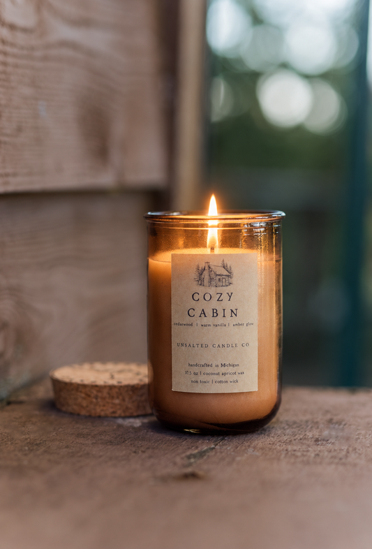 candle in cabin glowing warm fall autumn