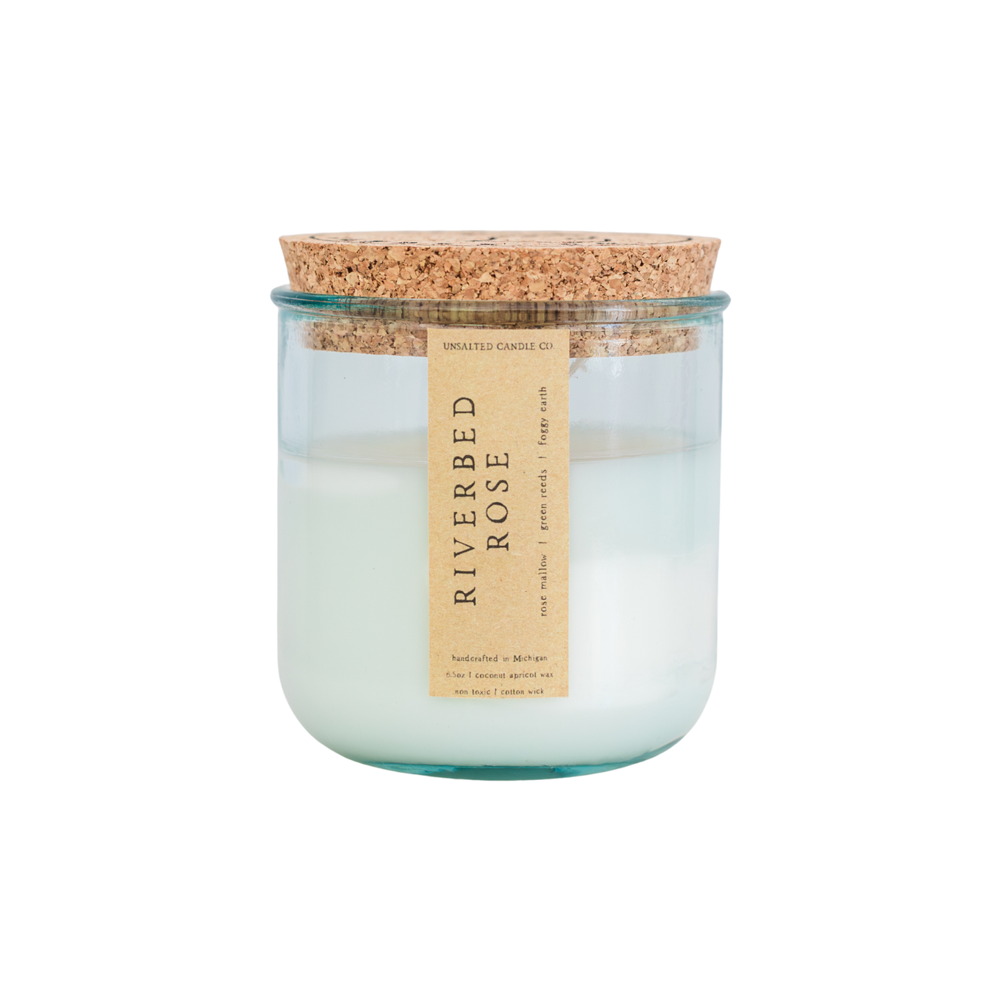 A glass jar candle with a cork lid and a beige paper label reading 'RIVERBED ROSE' on a plain white background.