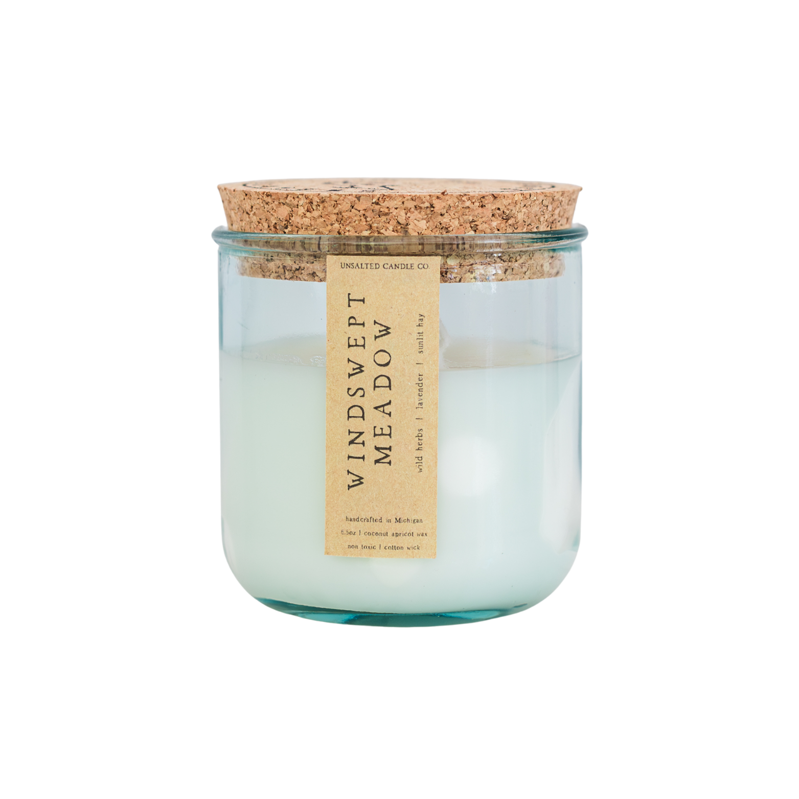 A glass jar candle with a cork lid and a beige paper label reading 'Windswept Meadow' and 'Smuggler's Candle Co.' on a plain white background.