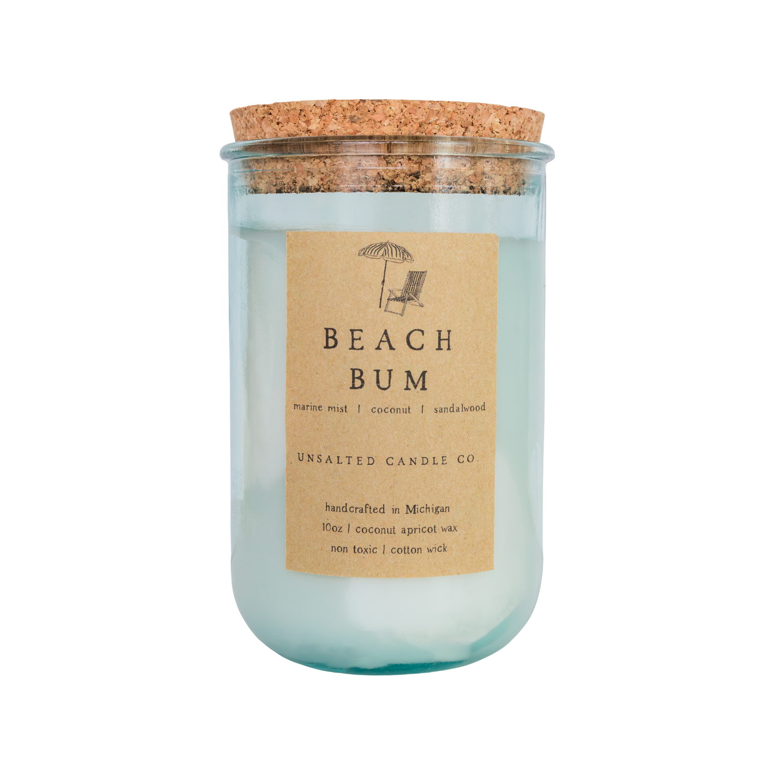 A beach-themed candle in a clear glass jar with a cork lid, featuring a light blue wax body and a tan paper label that reads 'BEACH BUM' and 'UNSALTED CANDLE CO'.