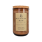 A jar candle with amber-brown wax in a clear glass jar, topped with a natural cork lid and featuring a beige paper label that reads 'MICHIGAN MAN' and 'UNSLATED CANDLE CO.' on a plain white background.